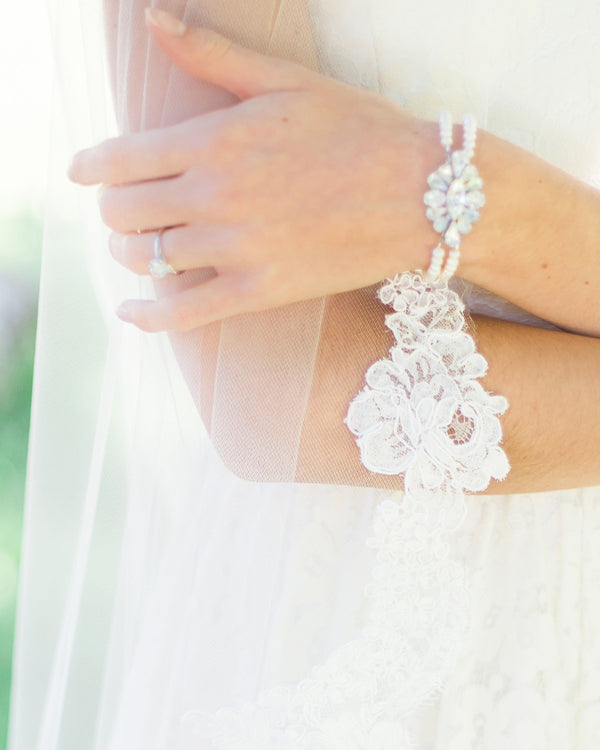 Close view of a bride wearing the Petite Pearl & Crystal Brooch Bracelet.
