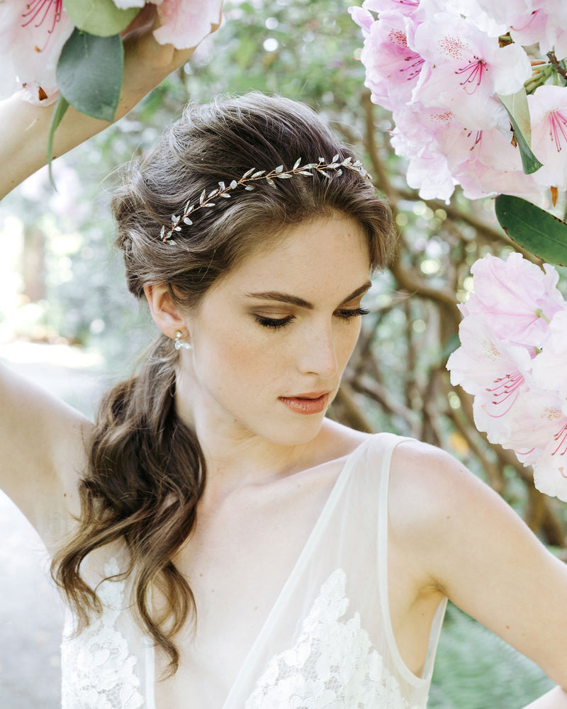 A bride wears the Sea Mist Hair Vine in rose gold with moonstone, and crystals.