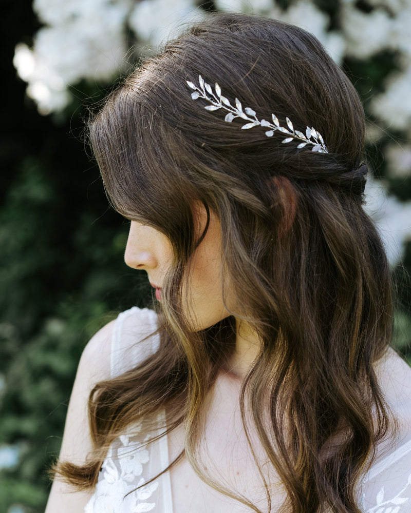 A bride wears the Sea Mist Bridal Hair Comb in silver with rose quartz gemstones.