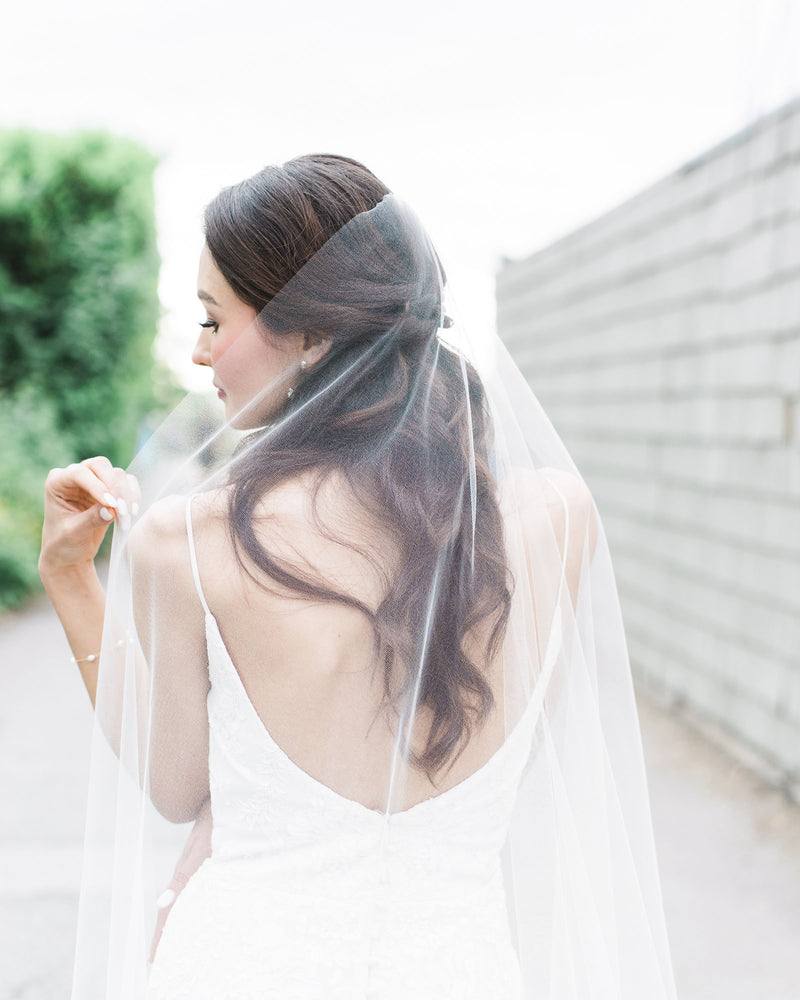 Close model view of the comb and hand-cut edge on the Senna Lace Veil.