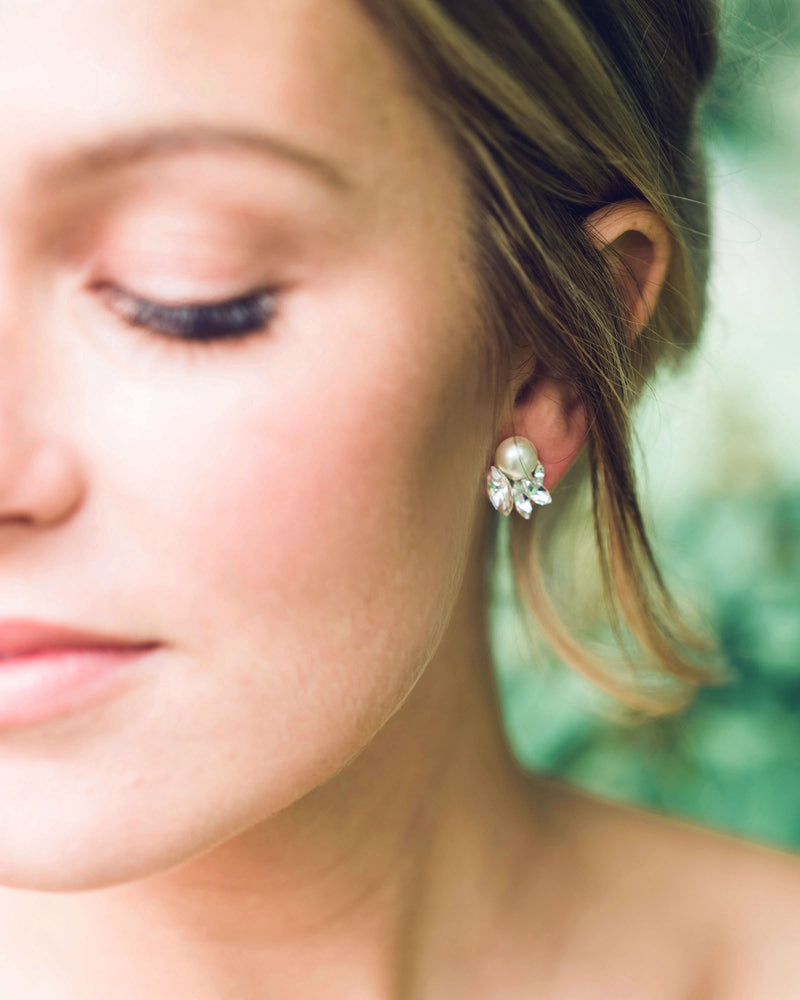 A close model view of the Starlight Bridal Stud Earrings with crystals and cream pearls.