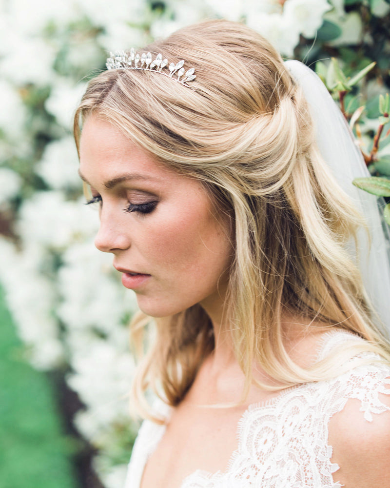 A bride wears a delicate crown made of sparkling crystals.