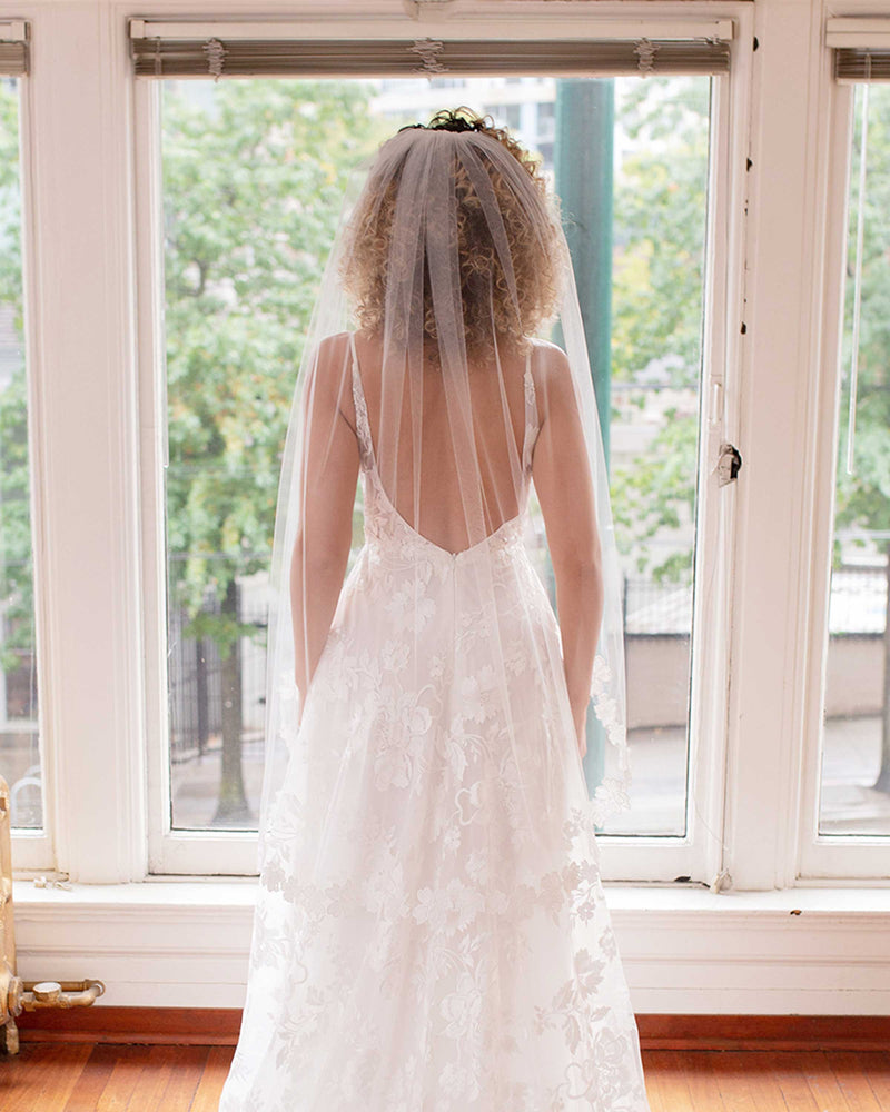 A close back view of the Wildflower Floral Lace Veil in fingertip length.