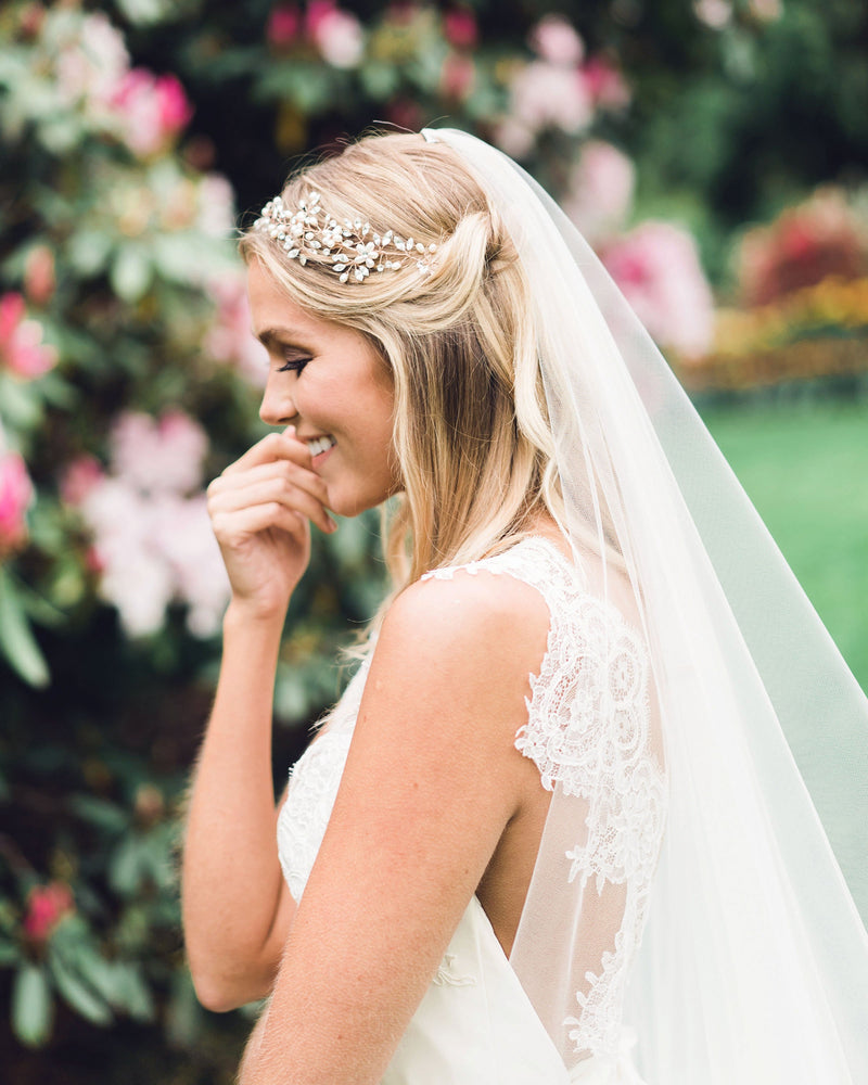 A bride wears the Zahra Horsehair Trim Veil in chapel length, with the blusher worn to the back.